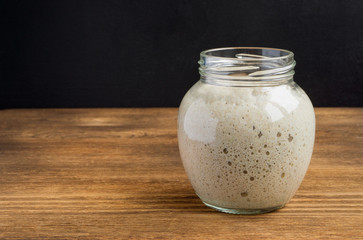 Active rye sourdough in a glass jar for homemade bread.