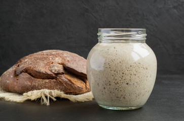 Active rye sourdough in a glass jar for homemade bread.