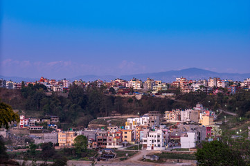 Fototapeta na wymiar City Under the Evening Sunset and a Background of the Himalaya Mountain Range