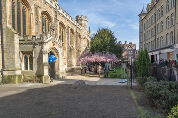 View of the exterior facade of the Great St Mary's Church and St Mary passage street with people