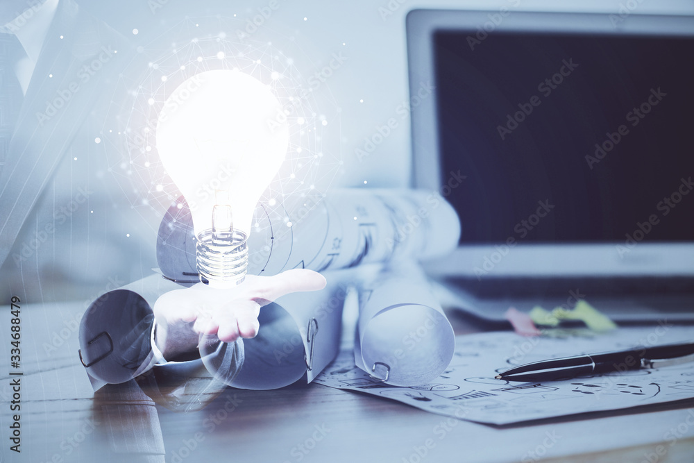 Poster computer on desktop in office with bulb icon hologram. multi exposure. concept of idea.