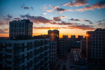 View on the beautiful sunset over the city. Cityscape after sunset. Space for text. Selective Focus.