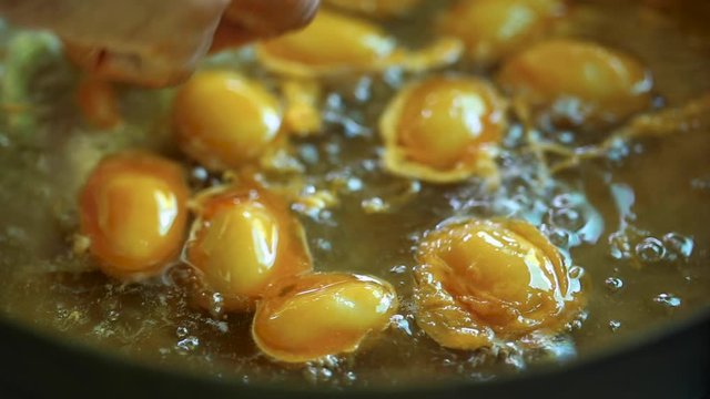 How to made thai dessert, close up fo Bean paste or Med Kanoon boiling in syrup in bronze pan.The most famous of Thai dessert. 
