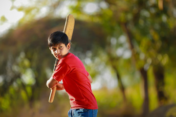 Rural Indian Child Playing Cricket