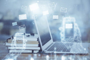 Desktop computer background in office and flying envelops hologram drawing. Multi exposure. Electronic mail concept.