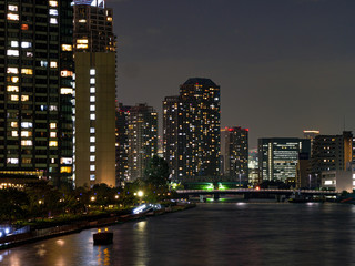 Fototapeta na wymiar High rise buildings in Tokyo reflected in a river