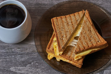   Tasty sandwich for breakfast on the table with coffeee           