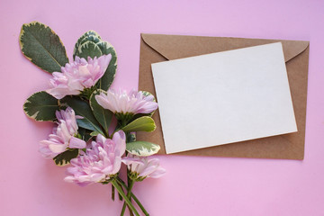 card mockup on white table with chrysanthemums. flowers. flat lay