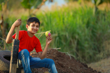 Fototapeta premium Rural Indian Child Playing Cricket