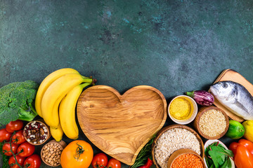 Background healthy food. Fresh fruits, vegetables, meat and fish on table. Eating for healthy heart. Healthy food, diet and healthy life concept. Top view, copy space