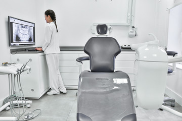 Dentist examining teeth X ray in office