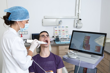 Dentist making 3D scan of client teeth