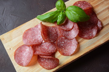 Sliced salami on cutting board