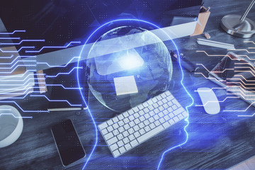 Double exposure of table with computer and brain hologram. Data innovation concept.
