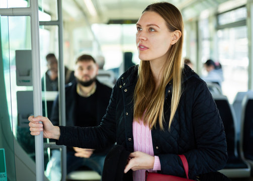 Young woman traveling by city bus