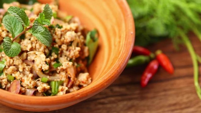 Thai tradition food : Larb moo is popular Thai food. Pork mix with chili and spicy herbs. Served with vegetable,sticky rice. Selective focus. Still life shoot in studio, Clean food good taste concept.