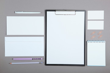 White stationery branding, stage layout on a soft colored background, empty objects to accommodate your design, inclined.
