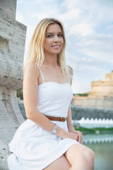 Young attractive lady posing on a bridge