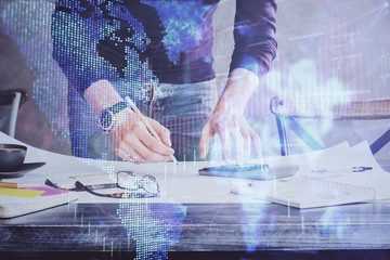 Multi exposure of man standing and planing investment with stock market forex chart.