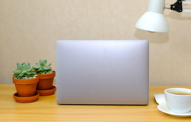 workplace. Wooden desk with laptop and coffee cup. designer working place