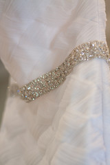 Closeup details of a white wedding dress