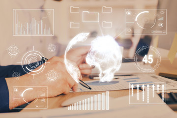 Double exposure of man's hands writing notes of stock market with forex graph.