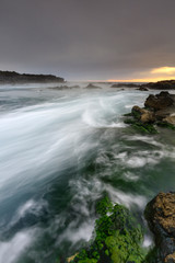 waves crashing on rocks at sunset, Iceland