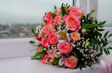 a bouquet of flowers lies on the window