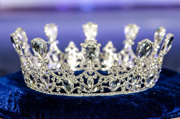 silver queen crown on blue background