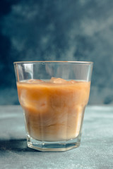 White russian cocktail with ice and cream liquor. Selective focus. Shallow depth of field.