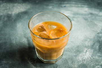 White russian cocktail with ice and cream liquor. Selective focus. Shallow depth of field.