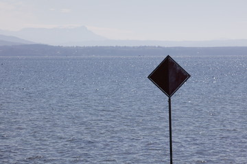 Sign in the shadow with a lake view