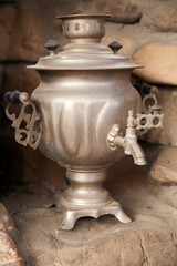 The silver samovar stands in a stone niche. An old iron samovar stands in the house during the day