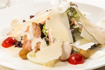 Fresh vegetable salad with cheese and meat. Close-up shot in a restaurant.