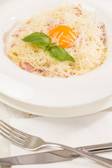 Spaghetti with egg and cheese closeup shot in a restaurant.