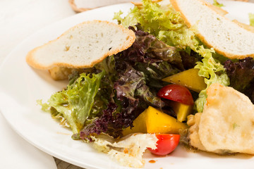 Fresh vegetable salad with cheese and meat. Close-up shot in a restaurant.
