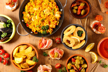 assorted of spanish food- tapas, paella, potato bravas, mussels