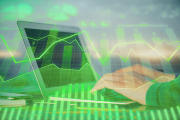 Double exposure of stock market graph with man working on laptop on background. Concept of financial analysis.