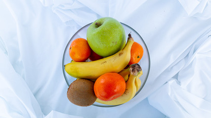bowl of different fruits on a white background