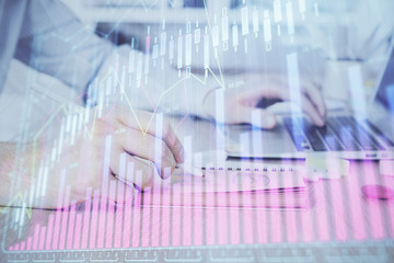 Multi exposure of financial graph with man works in office on background. Concept of analysis.