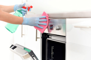 Woman in gloves cleaning kitchen.	 - obrazy, fototapety, plakaty
