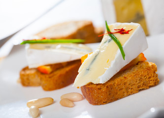 Canapes with soft blue cheese and orange