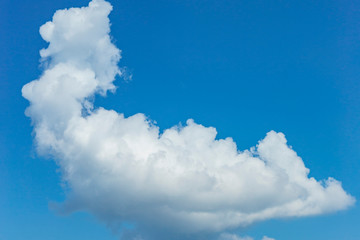 big white cumulus cloud in the blue sky as a natural background