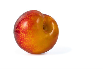 whole ripe juicy plum isolated on white background