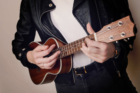 frau cool modern blonde locken jung spielt gitarre gitare