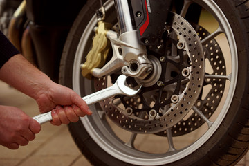  Technician hands repairing motobike, doing repair service, maintenance worker repairing vehicle with wrench, service and maintenance motocycle check    