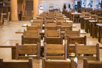 Rows of empty tables and chairs in a restaurant, cafe. Quarantine during coronavirus.