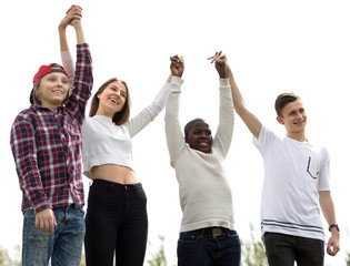multinational modern teens holding hands
