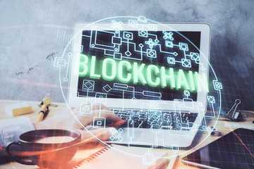 Crypto currency theme hologram with businessman working on computer on background. Concept of...