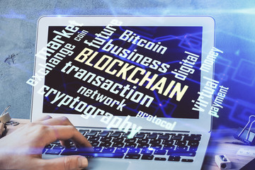 Crypto currency theme hologram with businessman working on computer on background. Concept of...